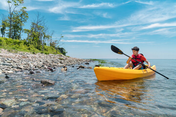 young man kayaking in the ocean