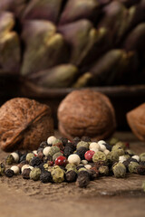 Macro close up of mixed peppers on a wooden table.