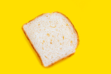Close up photo of fresh baked toast bread on yellow background. Top view. Bread for breakfast.