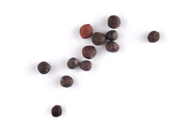 Upper view of shooting placers of rapeseed grains lying on a white background. Cuted out with saved...