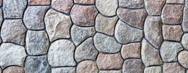 Natural rock wall texture and pattern. A surface or structure made of stone blocks.