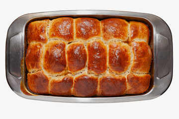 Homemade sweet buns with golden crust in a pan on white background, cut out