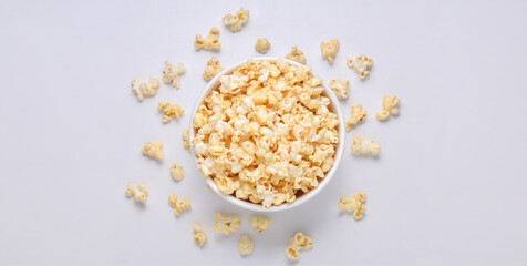 Obraz na płótnie Canvas Salted popcorn in bucket on white background. Top view. Copy space