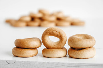 Fototapeta na wymiar Drying or mini round bagels on a white wooden background. Copy, empty space for text