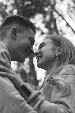 Couple leaned against each other noses black and white photo