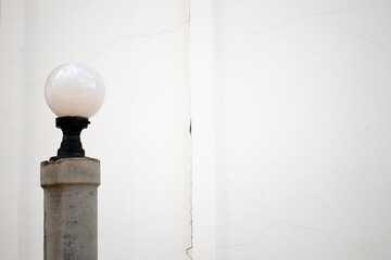 gray old lamp on the  white wall bright background