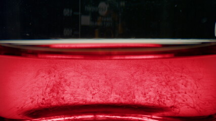 Blood particles dissolving in water. Blood cells moving in test tube