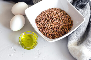 buckwheat in a bowl with eggs and oil