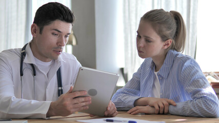 Doctor Discussing Results on Tablet with Patient