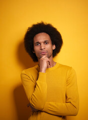 Fototapeta na wymiar Portrait of thoughtful Afroamerican in yellow