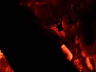 Fototapeta premium Close up shot of firewood burning in a fireplace-texture or background, abstract
