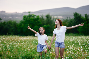 Fototapeta premium Beautiful woman and little girl in nature