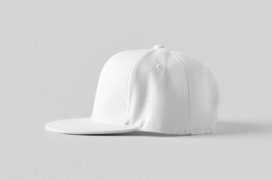 White snapback cap mockup on a grey background, side view.