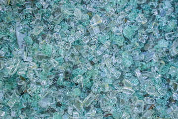 texture of broken glass as background. A lot of fine shards and pieces of shattered glass