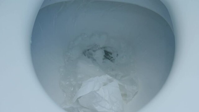 flushing of toilet tissue paper down a bathroom toilet