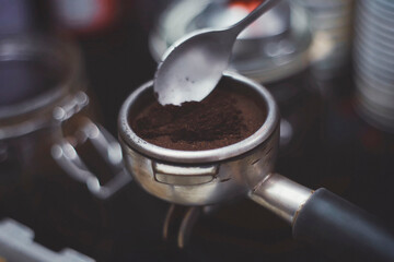 Making espresso with freshly ground coffee and machine