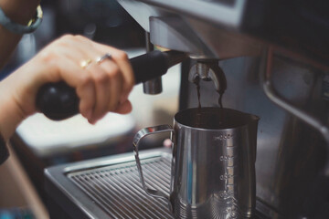 Fototapeta na wymiar Making espresso with freshly ground coffee and machine