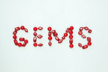 Red sign composed with red gems on white background.