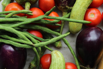 Green beans display with selective focus and fresh various raw organic vegetables for healthy and diet background.