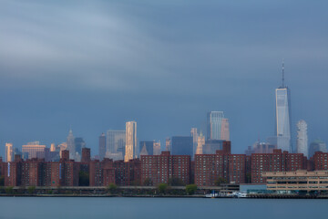 Fototapeta premium View on Lower Eastside from East River with long exposure at sunrise.