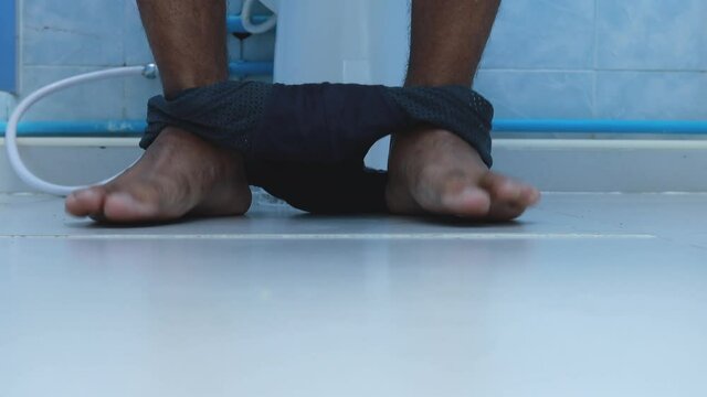 Young man took off panties while sitting defecate on the toilet