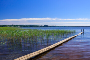 Wooden pier on the lake. Kavgolovskie lake is a popular vacation spot near the village of Toksovo, Leningrad region, Russia