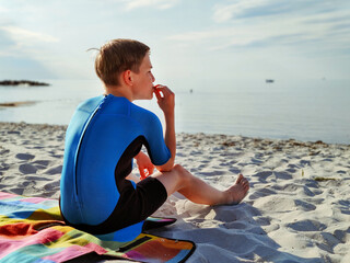 Handsome teen boy in neoprene swimsuit in Baltic sea © spass