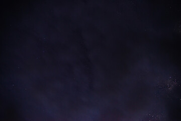 Fototapeta na wymiar Stars in the night sky through the clouds on a summer night