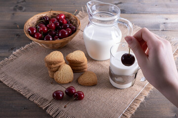 juicy cherries and cookies with milk