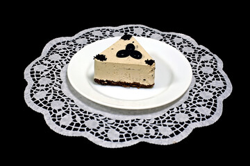 Tasty coffee cake on a white napkin. On a dark background. Close-up.