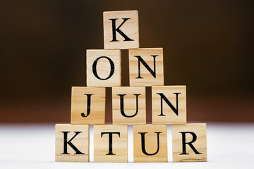 Wooden blocks with german word conjuncture, stumulus package and finance