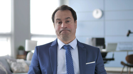 Middle Aged Businessman Gesturing No by Shaking Head