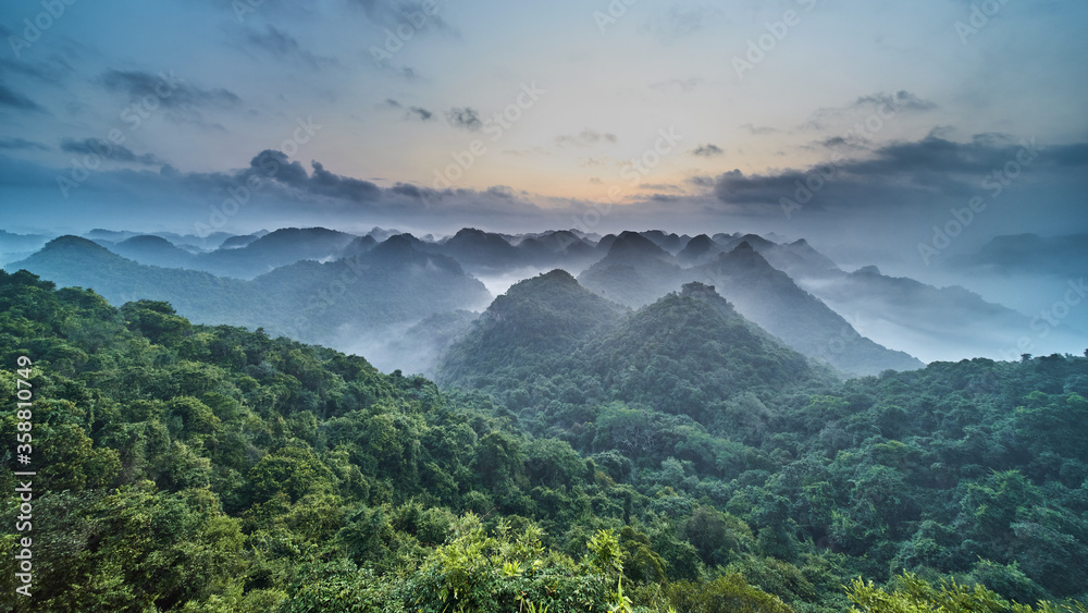 Wall mural Panoramic view of the CatBa National Park, Vietnam. View from the top of the jungle hills of karst cliffs at dawn.