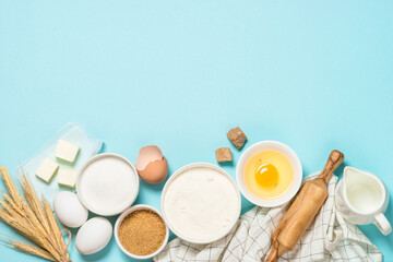 Baking ingredients at blue table top view.