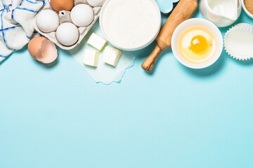 Baking ingredients at blue table top view.