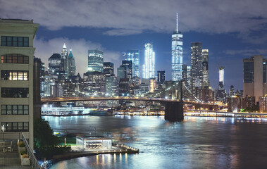 Fototapeta na wymiar New York cityscape at night, Brooklyn Bridge and Manhattan seen from Brooklyn Dumbo, color toning applied, USA.