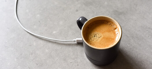 Concept for charging mobile device by sharing charge from caffinated drink