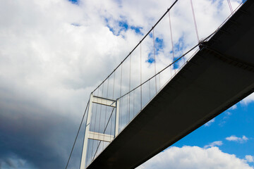 Pylon of suspension bridge against cloudy sky