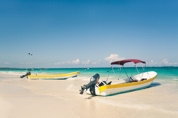 Fototapeta na wymiar Motor boats moored on white sandy beach, Tulum, Yucatan, Mexico