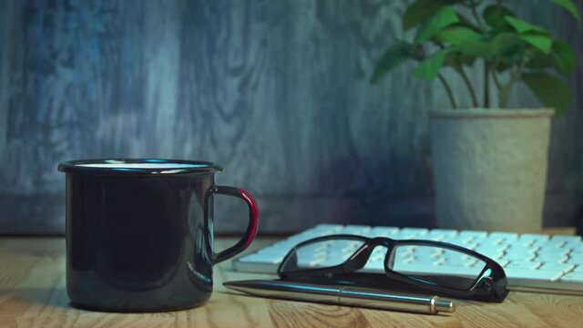 Smoking hot cup of coffee on a desk. A seamless loop