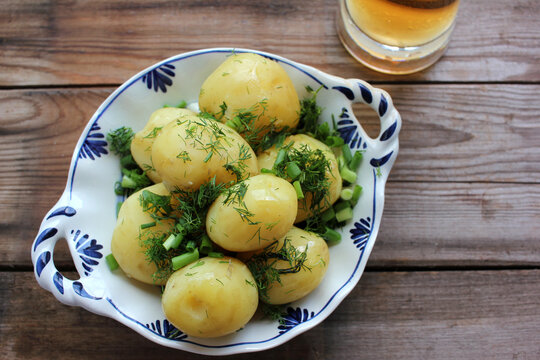 Traditional Swedish Midsummer Food Boiled Potatoes With Dill And Chopped Onion And Light Beer On The Old Wooden Board Table. Top View