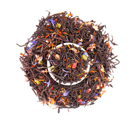 Black Ceylon tea with candied fruit, saffron, rose and cornflower petals, isolated on white background. Organic tea. Top view. Close up.