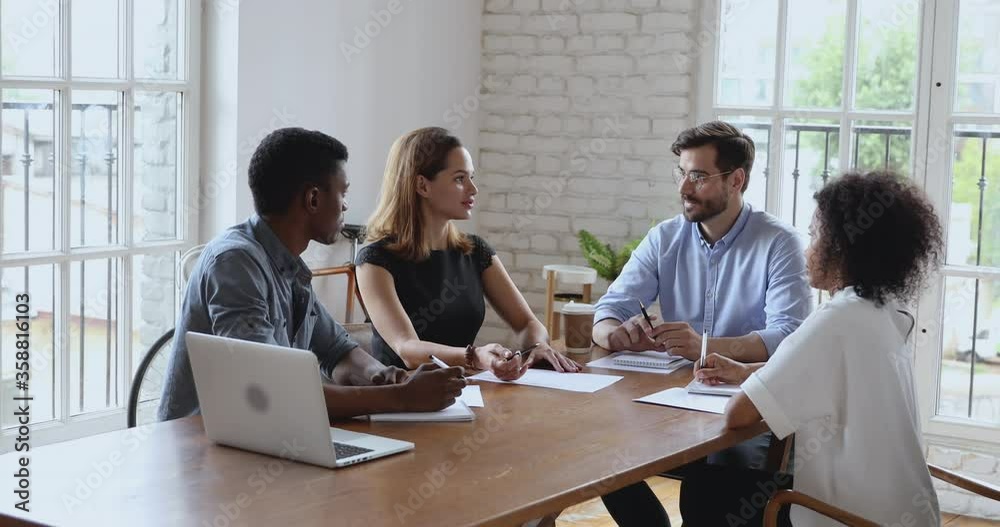 Wall mural female executive communicating with boss and diverse team at office meeting, multiracial business st