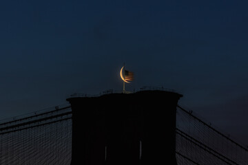 Crescent moon over Brooklyn bridge with an American flag - Powered by Adobe