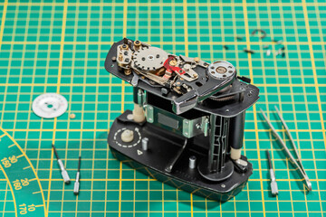 medium format film magazine dismantled on green background