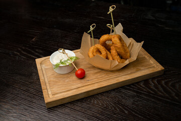 onion ring with sauce on wooden board