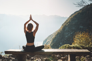 Young woman is meditating in mountains.