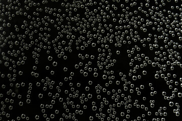 Tiny air bubbles in black water background