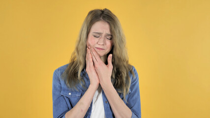 Toothache, Young Pretty Girl with Tooth Pain on Yellow Background