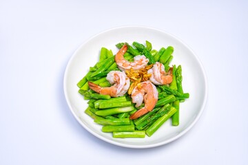 Stirred fried asparagus with shrimp served on white plate isolated on white background. famous thai food in thailand. popular food in Asia.